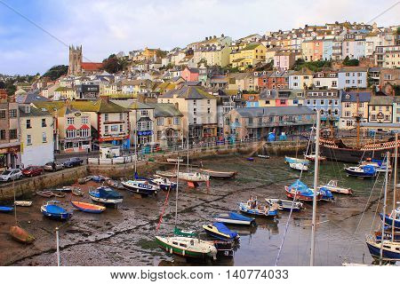 Brixham, Devon, Uk, Nov 02 2015: Small Boats Moored At Low Tide In The Fishing Port, With The Town O