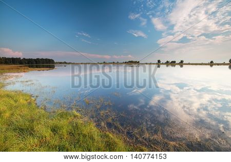 blue sky reflected in wild lake Drenthe Holland