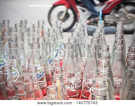 BANGKOK, THAILAND - JUNE 25: Empty recycle bottles of Coca Cola in red plastic box on June 25, 2016 in Bangkok, Thailand. Coca Cola drinks are produced and manufactured by The Coca-Cola Company