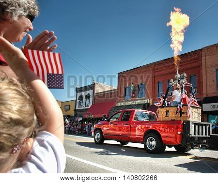 KALISPELL, MT, USA - JULY 4: Spectators watch as a hot air balloon blasts fire into the air during the 4th of July Parade in Kalispell, Montana, on July 4, 2016.