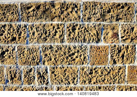An ecru or camel, umber brickwall texture
