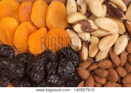Punes Plums Castanha do Para and almods over a wooden table