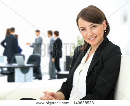 Beautiful business woman with co-wokers at background