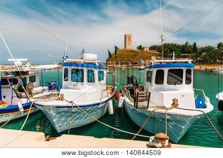 NEA-FOKEA GREECE - MAY 24 2015: Boats in the background of Nea-Fokea Tower. Kassandra of Chalkidiki peninsula in Greece