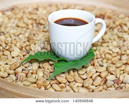 luwak beans and white cup of coffee in a basket