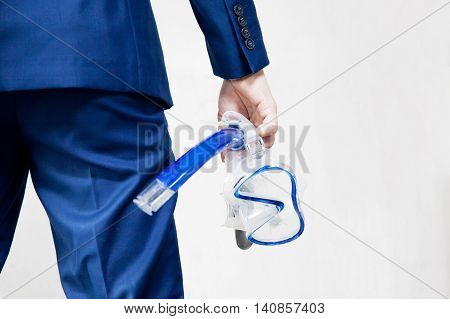 Businessman Holding Snorkeling Goggle In White Background - Business Vacation Concept