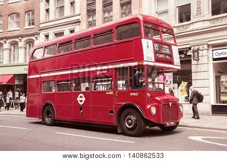 LONDON - JUL 02 2015: Vintage red double-decker bus in a street of London UK.