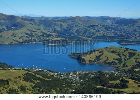 Akaroa Harbour and mountains. Landscape on the Banks Peninsula New Zealand. Bay town farmland and mountains.