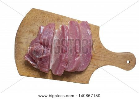 Isolated fresh meat on a wooden cutting board.
