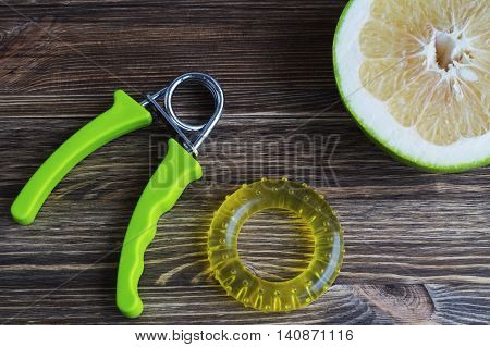 The concept of a healthy lifestyle. Pamela fruits and a few hand expander.