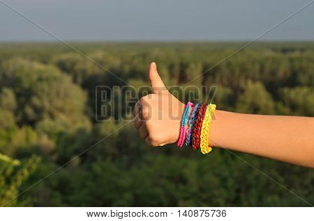 сhild's hand with a bracelet thumbs up