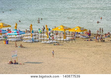 Mamaia Romania - July 18 2016:Group of tourists enjoying on beach in MamaiaMamaia is the best known resort on Romanian Riviera.It's situated on 8km long and 300m wide sandy land at the Black Sea.