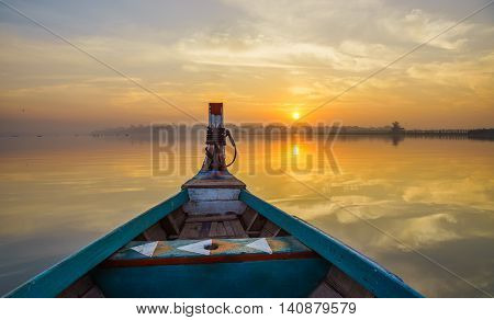 Wooden boat in Ubein Bridge at sunrise Mandalay Myanmar (World longest wooden bridge)