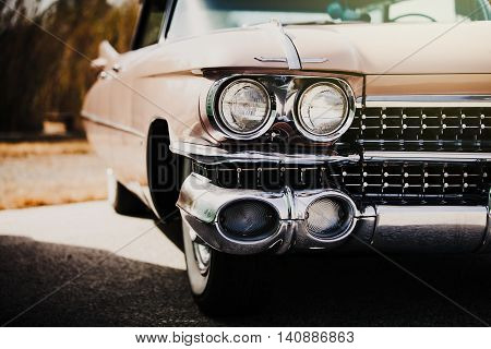 Detail of front light of an american vintage car.