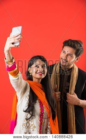 Indian brother taking selfie with sister on Raksha Bandhan festival after tying knot or rakhi