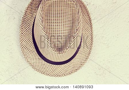 hat hanging on an old wall vintage retro effect