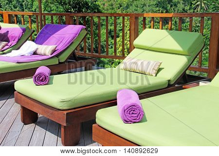 deck chairs with towels by the pool