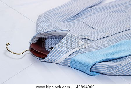 Men's classic shirts on the bed. Shallow depth of field