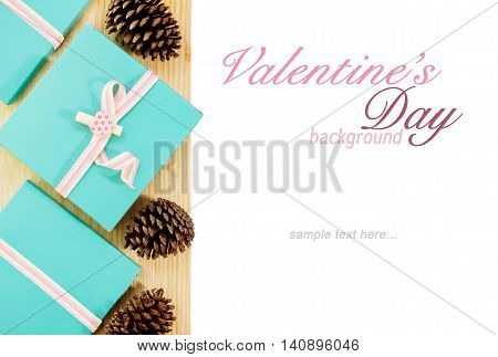 Blue gift boxes with pink ribbons and fircones partly isolated on white. Valentines day love romance background. Text space
