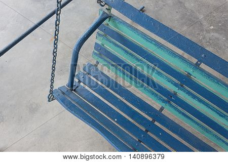 Close up Porch swing. Old porch swing painted blue.