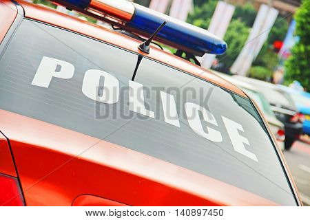 Closeup of the orange police car with a sign POLICE.