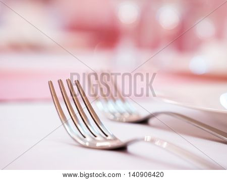 Two kitchen forks on dinner table. Selective focus. Shallow DOF