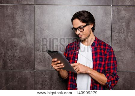 Handsome Young Man In Glasses Using Digital Tablet
