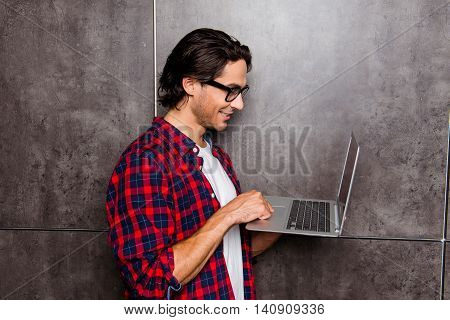 Handsome Young Man In Glasses Using Laptop, He Chatting With Friends