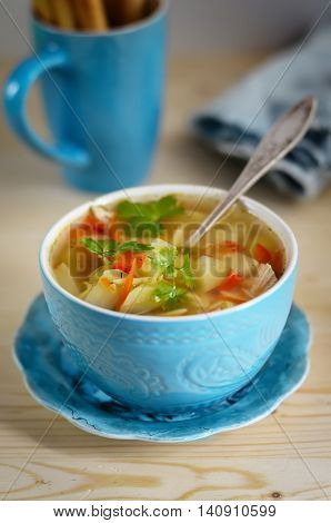 Soup in a blue ceramic bowl kvass and bread sticks