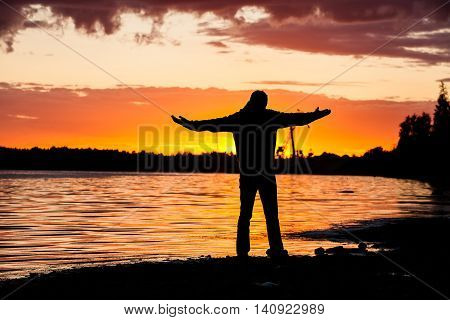 Sunset and silhouette of oilfield worker in the oilfield monitoring valves