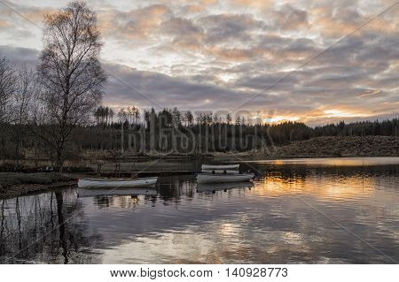 Three fishing boats at sunset on loch Rusky