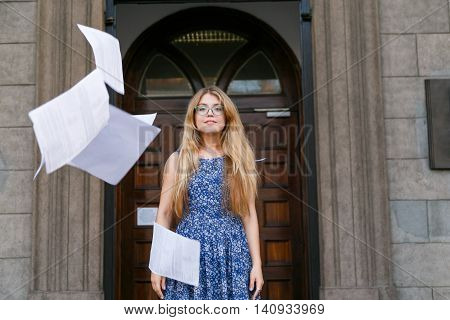 Young woman threw the papers in casual and paper flying in air. Freedom concept