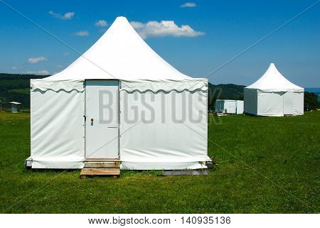 White tent on the green grass during the day