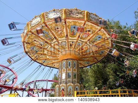 ALMATY KAZAKHSTAN - AUGUST 2 2016: The Fantasy Amusement park located in Almaty Kazakhstan. People ride and get the adrenaline.
