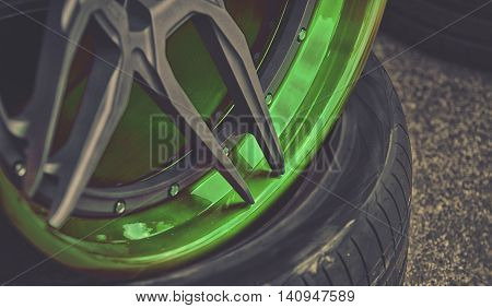 Closeup Detail Of Green Aluminum Car Wheel