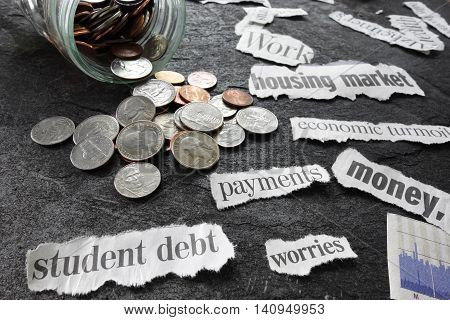 Economic news headlines with coins from a coin jar