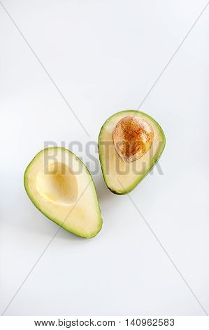 Avocado Cut In Half With Pit Seed On White Background
