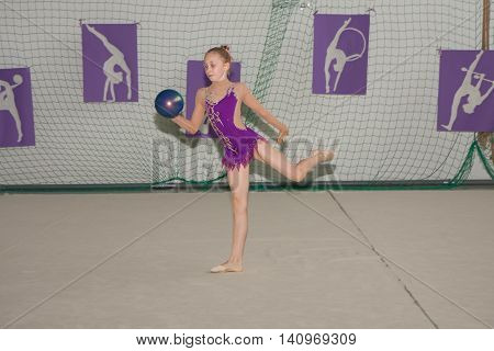 Warsaw Poland - June 25 2016: Young gymnast is with a ball