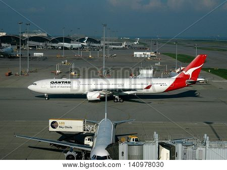 Hong Kong China - May 20 2004: A Quantas Airlines plane taxis on the tarmac at Hong Kong International Airport