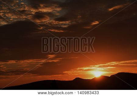 Orange sunrise in Austria mountains in summer time in village Maiersdorf