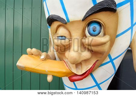 Closeup of funny toy with blue eayes eating ice-cream