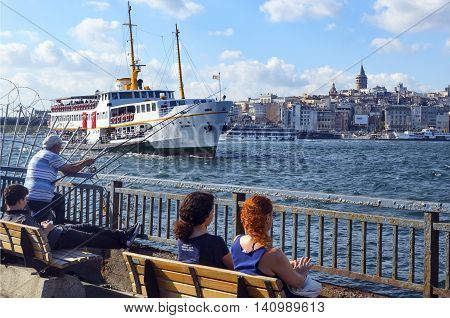 Istanbul Turkey - July 26 2016: Galata Bridge and Galata Tower in the background Istanbul views. This is a great place to see the colors of Istanbul at . Interesting to see the fishermen on the bridge with the Galata tower in the background. There are lot