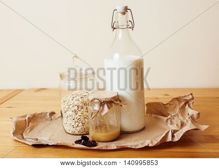 real comfort wooden kitchen with breakfast ingredients close up in glass, honey, oatmeal, milk, muesli, morning food