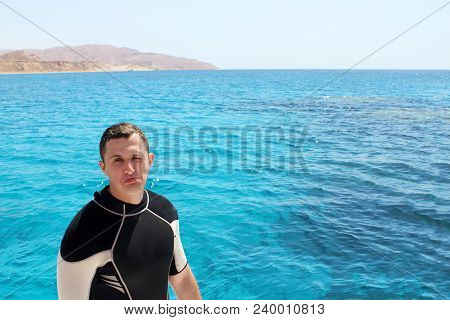 Diver In A Suit For Diving Is Preparing To Dive.
