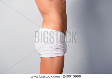Concept Of Intimate Man's Health. Size Profile Photo Of Sportive Athletic Man's Body, He Is Wearing 