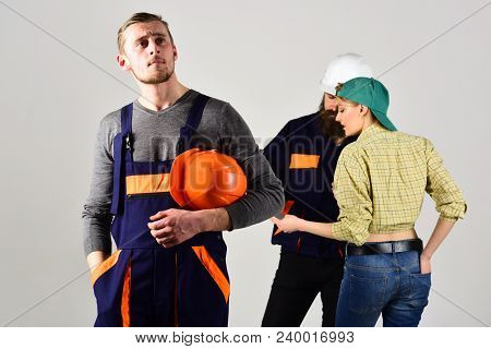 Worker Dreaming While Colleagues Signing Contract Behind Him. Brigade Of Workers, Builders, Repairer