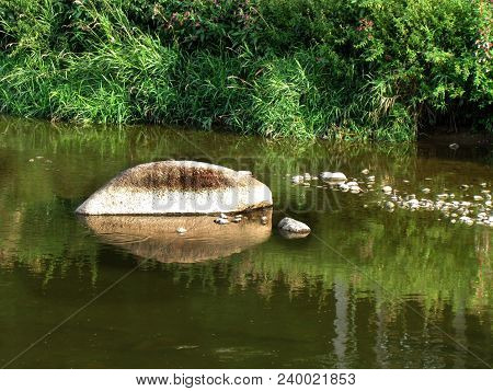 Stones In The River, A Rock Protruding Above The Water Surface, An Idyllic Natural Shot