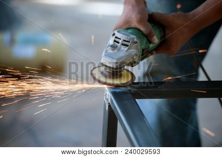 The Worker Is Welding Metal Part Of Table Steel In Factory.