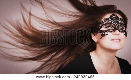 Pretty Mysterious Woman Wearing Black Eye Lace Mask Having Tousled Windblown Long Brown Hair.