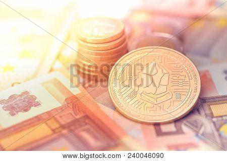 Shiny Golden Lisk Cryptocurrency Coin On Blurry Background With Euro Money Token